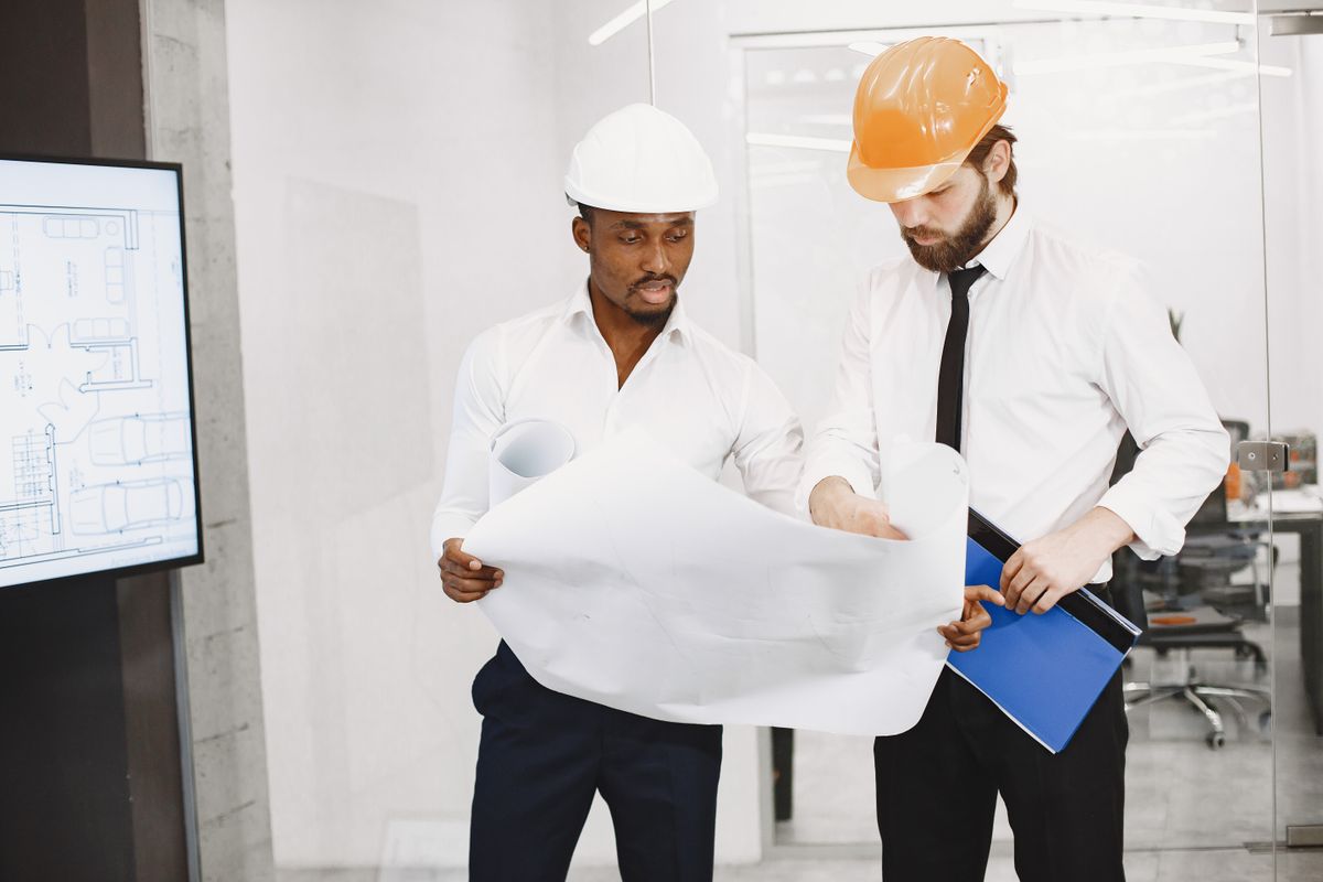 Two construction professionals reviewing a drawing