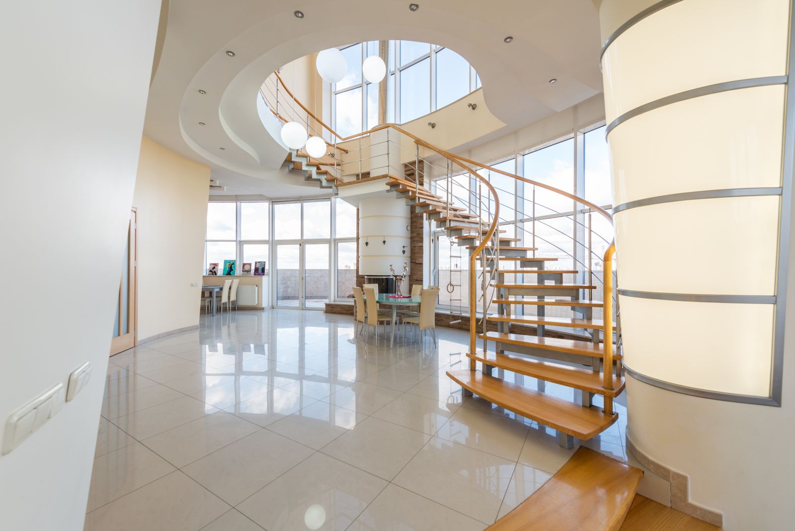 Bright architectural interior with a curved timber staircase