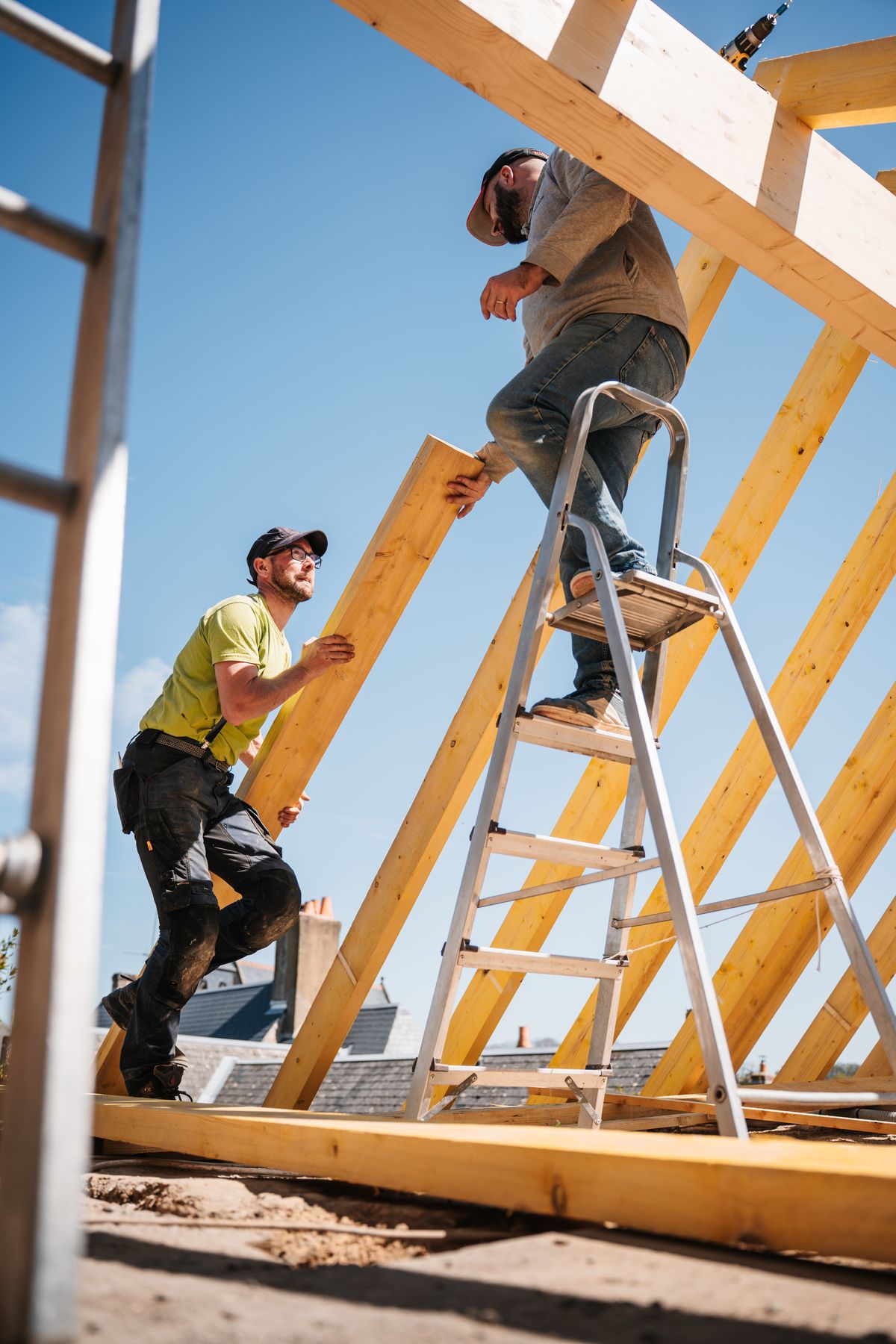 Workers assembling timber roof framing