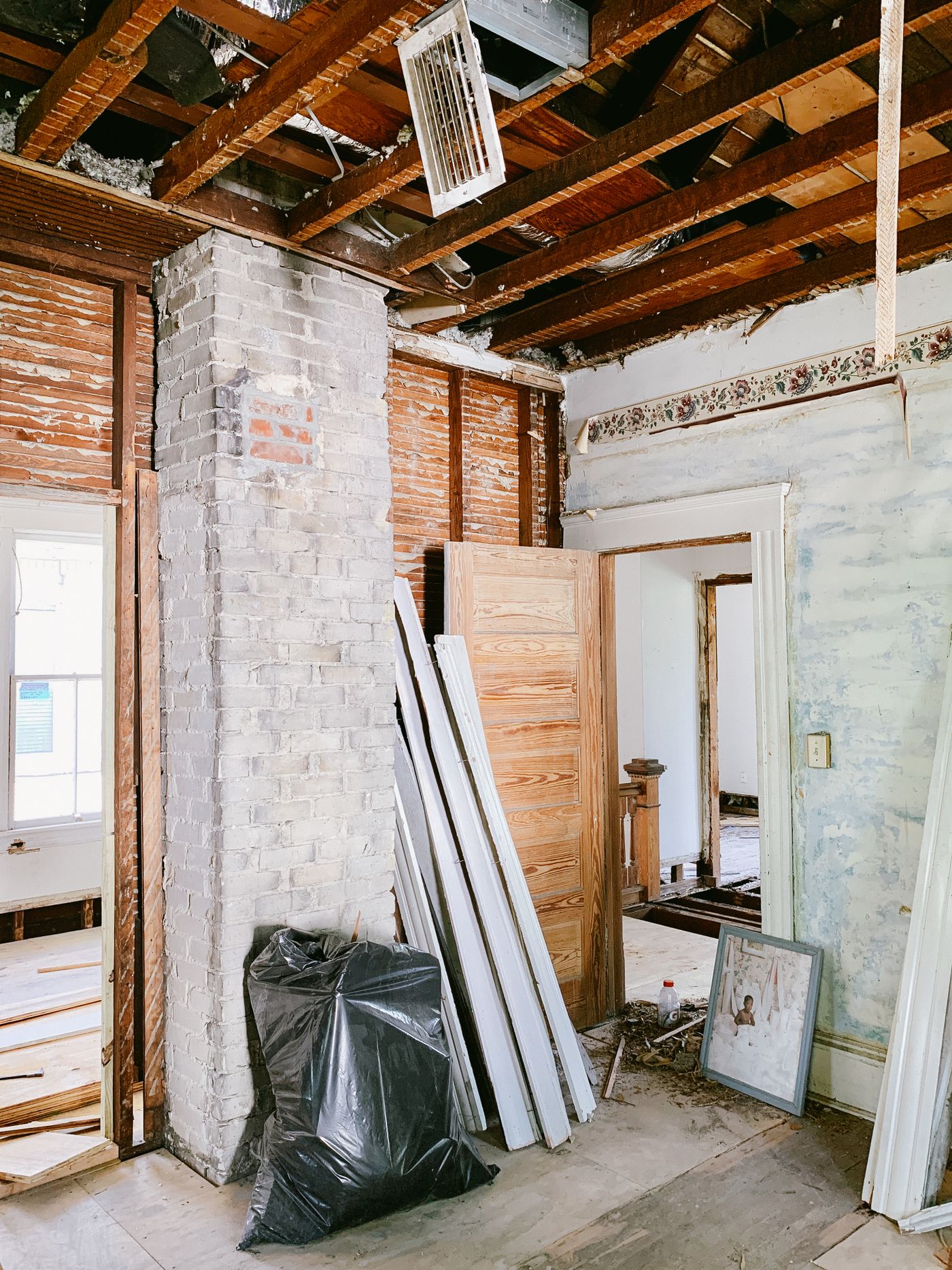 Stripped-out house interior with exposed timber and brickwork