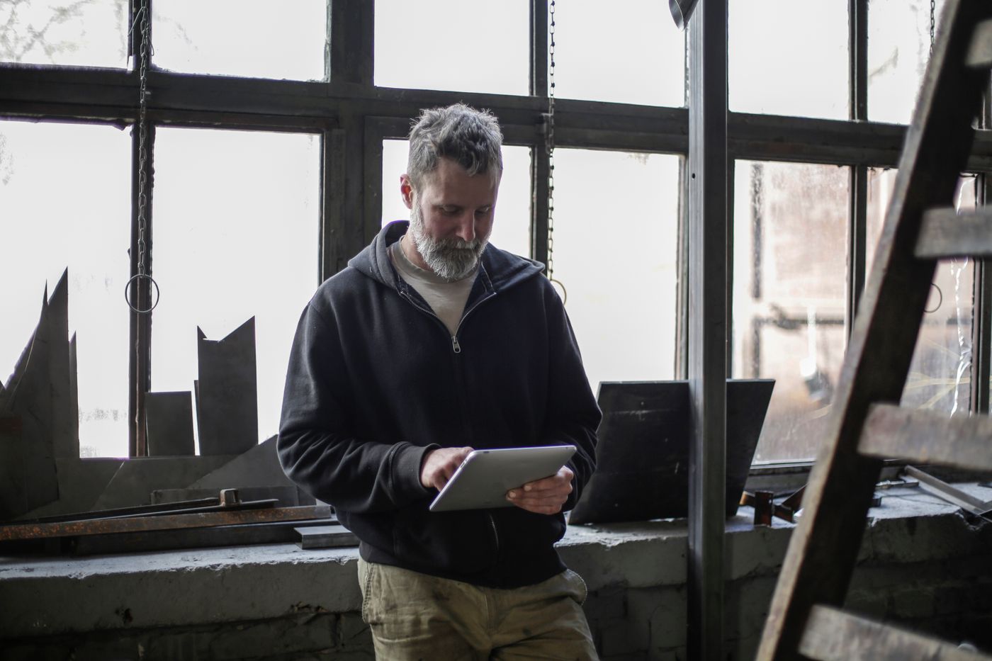 Tradesperson reviewing a tablet in a workshop